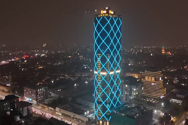 A beautifully lit high-rise building facade at night